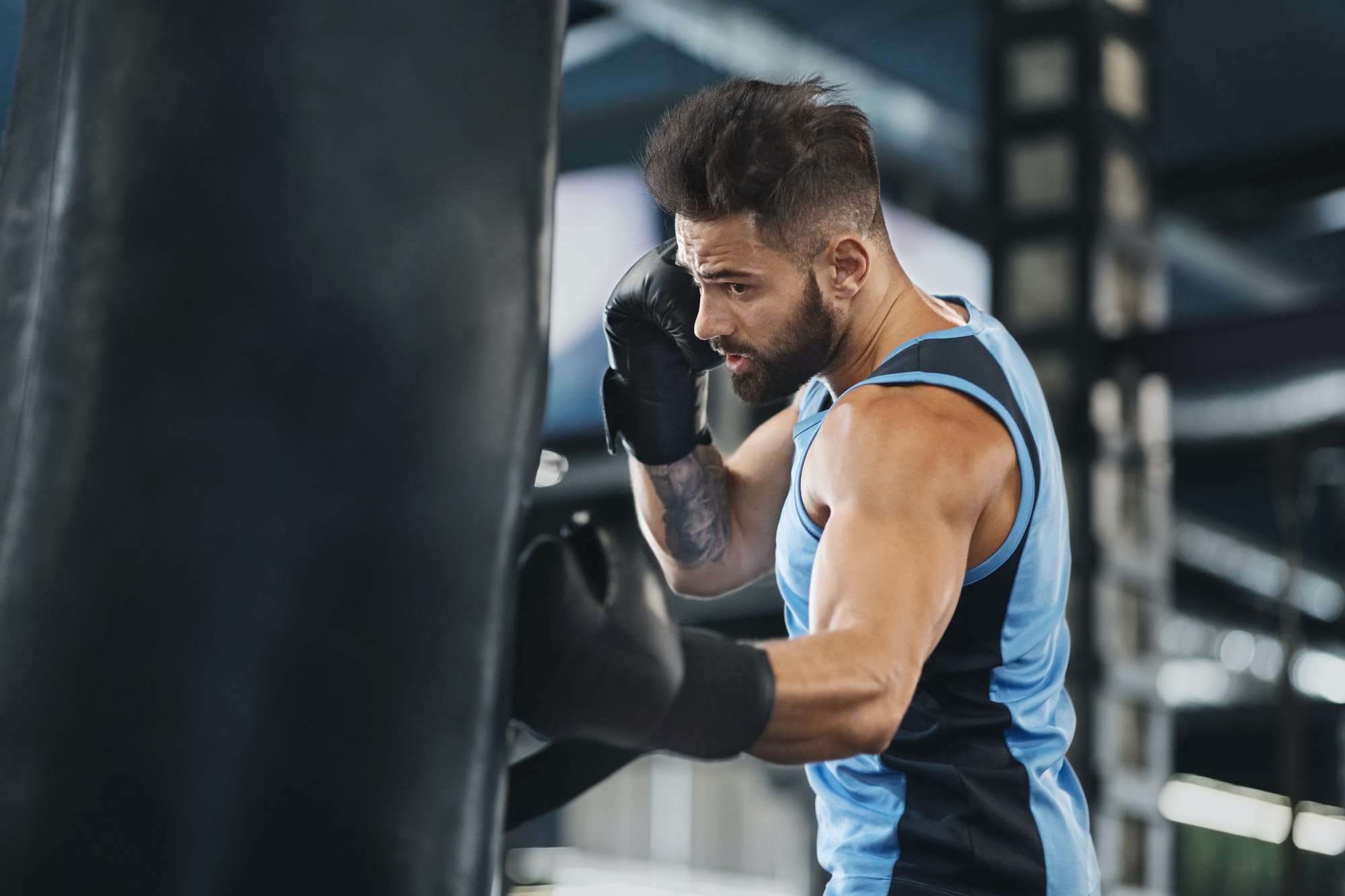 active-guy-punching-boxing-bag-at-gym.jpg