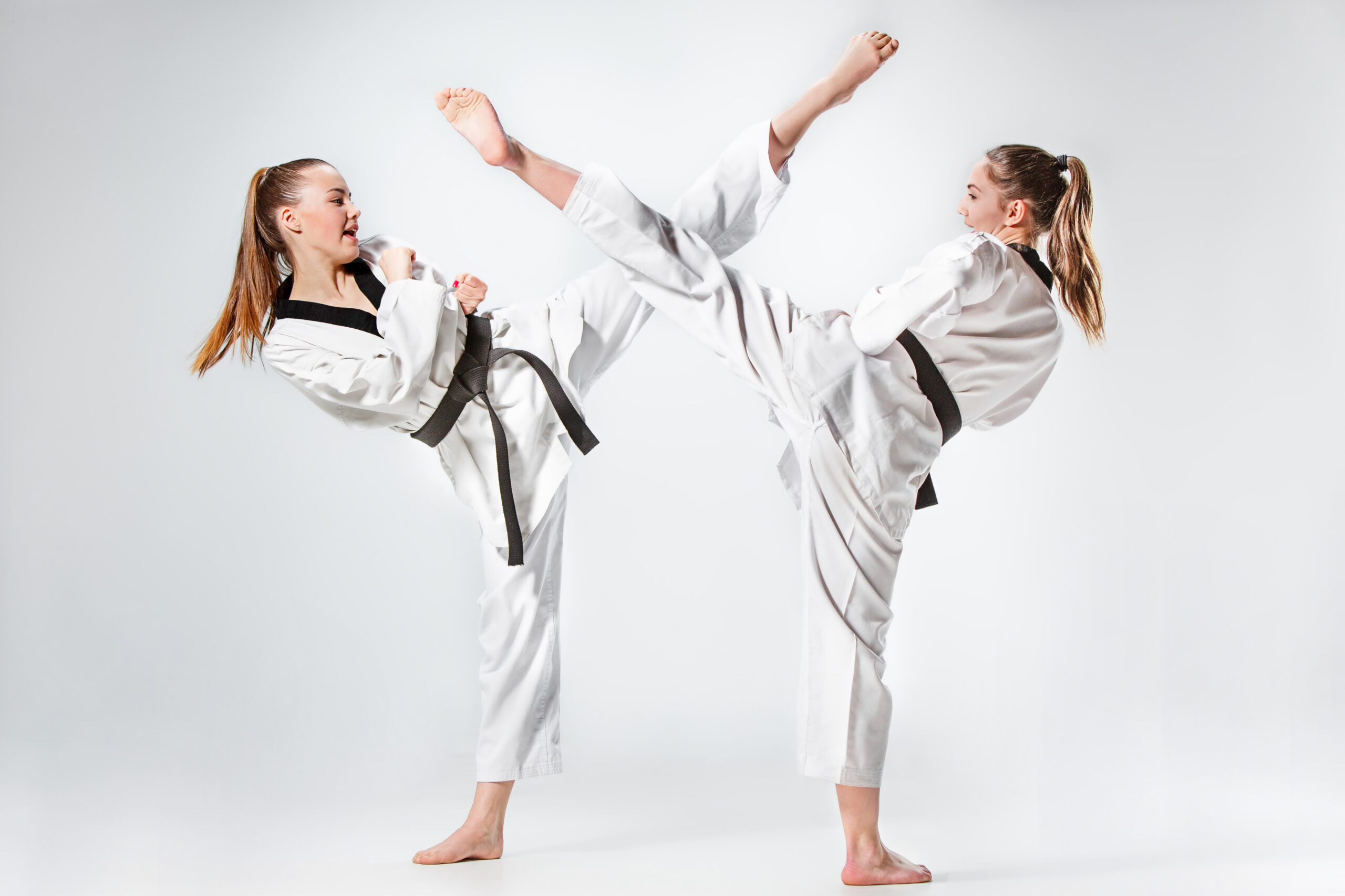 The studio shot of group of kids training karate martial arts on gray backlground